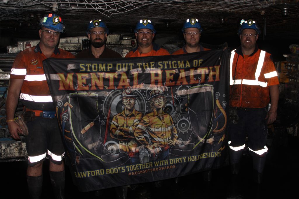 Centennial Mandalong Area 2 crew – taken at Mandalong Mine, showcasing the 'Stomp out the Stigma' of Mental Health Banner