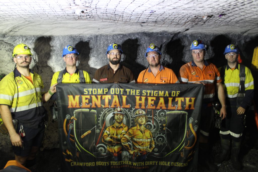 Centennial Mandalong Area 2 trades – taken at Mandalong Mine - showcasing the 'Stomp out the Stigma' of Mental Health Banner – 22 May