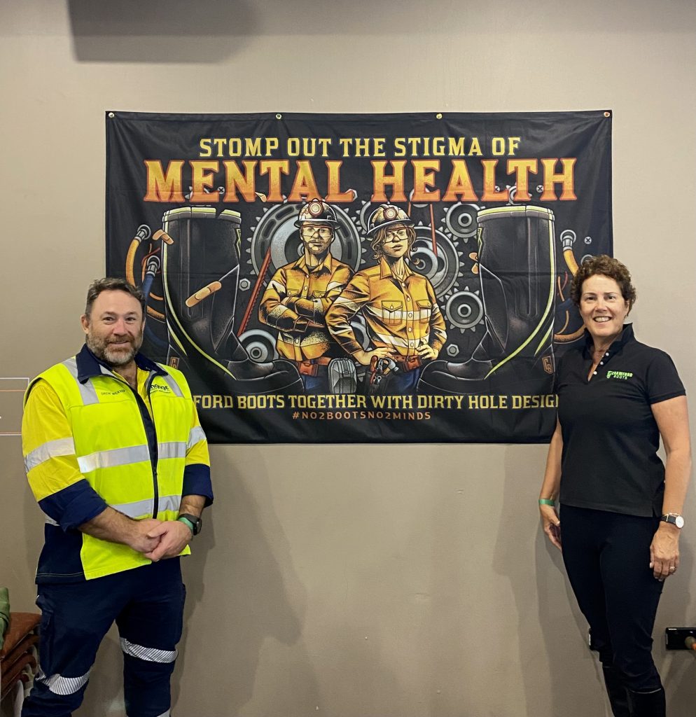 Penny Crawford and Drew Weaver of Engage Safety Management showcasing the 'Stomp out the Stigma' of Mental Health Banner